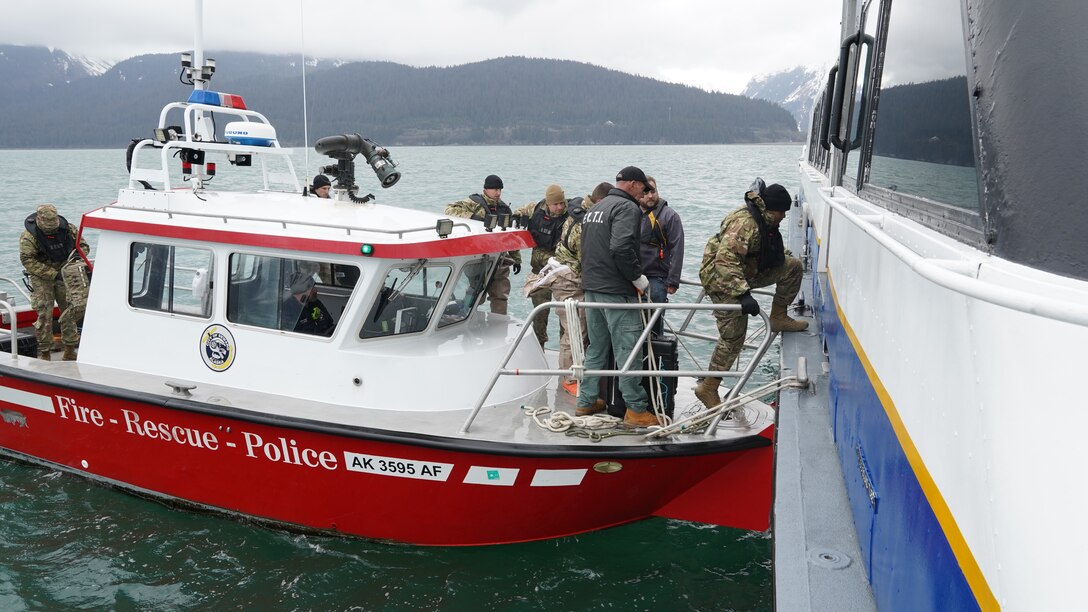 The Seward Alaska Fire Department transport members of the 13th Civil Support Team, Rhode Island National Guard, out to a simulated incident site aboard the Glacier Express vessel cruising through Resurrection Bay off of the coast of Seward, Alaska, May 19, in support of Exercise ORCA 21. ORCA is a chemical, biological, radioactive, nuclear threats response exercise designed for participants to provide support in the aftermath of hazardous materials incidents. ORCA tests interoperability between agencies, increases opportunities for working relationships, and practices requests for assistance methods. Approximately 250 National Guardsmen from CST units in Alaska, California, Connecticut, Colorado, Idaho, Ohio, Oregon, Rhode Island, South Carolina, South Dakota, Washington, and Wisconsin are in Alaska to participate in Exercise ORCA 2021. Numerous support units and civilian agencies participated in the exercise as well. (U.S. Army National Guard photo by Dana Rosso)