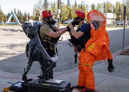 Sgt. Andrew Hunt, 103rd Civil Support Team, and Tech Sgt. Eric McComb, 103rd CST, prepare gear to respond to a simulated incident at a parking garage on the University of Alaska Anchorage campus May 18 in support of Exercise ORCA 2021. ORCA is a chemical, biological, radioactive, nuclear threats response exercise designed for participants to provide support in the aftermath of hazardous materials incidents. ORCA tests interoperability between agencies, increases opportunities for working relationships, and practices requests for assistance methods. Approximately 250 National Guardsmen from CST units in Alaska, California, Connecticut, Colorado, Idaho, Ohio, Oregon, Rhode Island, South Carolina, South Dakota, Washington, and Wisconsin are in Alaska to participate in Exercise ORCA 2021. Numerous support units and civilian agencies participated in the exercise as well. (U.S. Army National Guard photo by Spc. Grace Nechanicky)