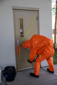 Tech Sgt. Eric McComb, 103rd Civil Support Team, prepares to enter a building to respond to a simulated incident at a parking garage on the University of Alaska Anchorage campus May 18 in support of Exercise ORCA 2021. ORCA is a chemical, biological, radioactive, nuclear threats response exercise designed for participants to provide support in the aftermath of hazardous materials incidents. ORCA tests interoperability between agencies, increases opportunities for working relationships, and practices requests for assistance methods. Approximately 250 National Guardsmen from CST units in Alaska, California, Connecticut, Colorado, Idaho, Ohio, Oregon, Rhode Island, South Carolina, South Dakota, Washington, and Wisconsin are in Alaska to participate in Exercise ORCA 2021. Numerous support units and civilian agencies participated in the exercise as well. (U.S. Army National Guard photo by Spc. Grace Nechanicky)