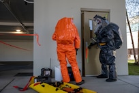 Sgt. Andrew Hunt, 103rd Civil Support Team, and Tech Sgt. Eric McComb, 103rd CST, prepares to enter a building to respond to a simulated incident at a parking garage on the University of Alaska Anchorage campus May 18 in support of Exercise ORCA 2021. ORCA is a chemical, biological, radioactive, nuclear threats response exercise designed for participants to provide support in the aftermath of hazardous materials incidents. ORCA tests interoperability between agencies, increases opportunities for working relationships, and practices requests for assistance methods. Approximately 250 National Guardsmen from CST units in Alaska, California, Connecticut, Colorado, Idaho, Ohio, Oregon, Rhode Island, South Carolina, South Dakota, Washington, and Wisconsin are in Alaska to participate in Exercise ORCA 2021. Numerous support units and civilian agencies participated in the exercise as well. (U.S. Army National Guard photo by Spc. Grace Nechanicky)