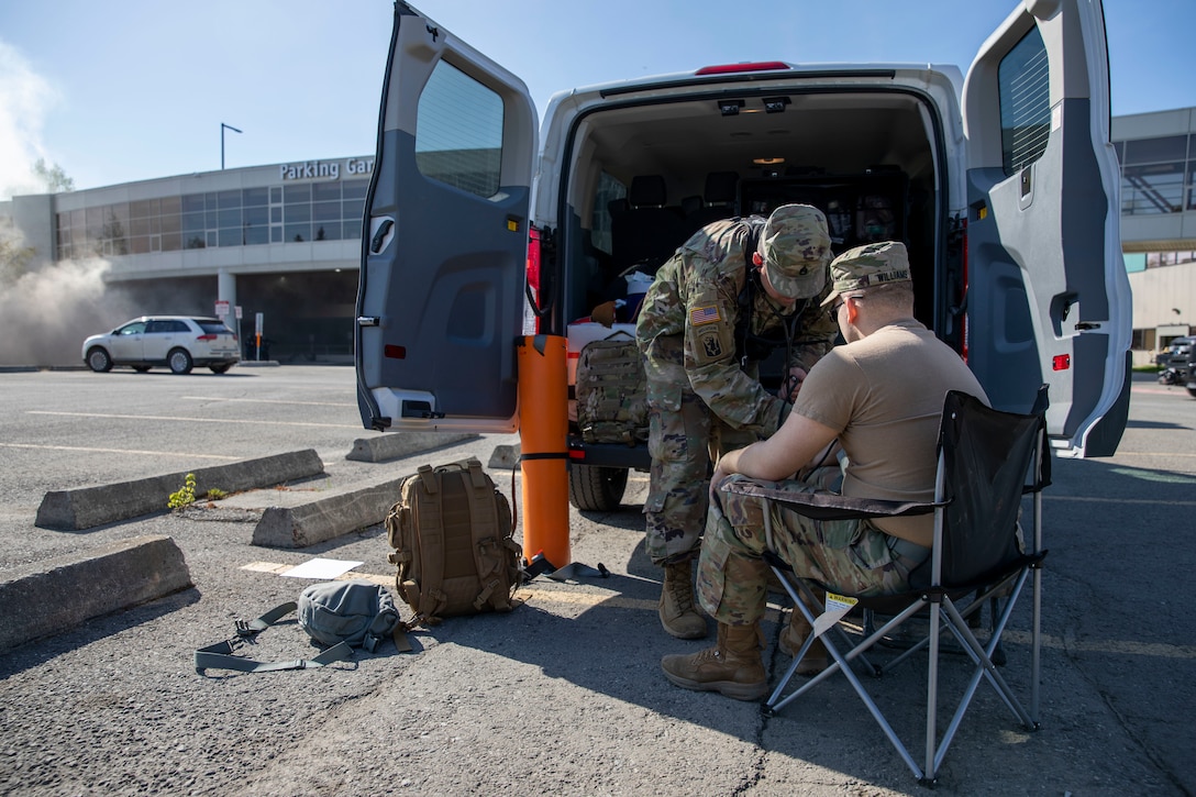 Staff Sgt. Ryan Curry, a medic with the 103rd Civil Support Team, performs a medical check on Sgt. Jason Williams, 103rd CST, before he gears up to respond to a simulated incident at a parking garage on the University of Alaska Anchorage campus May 18, in support of Exercise ORCA 2021. ORCA is a chemical, biological, radioactive, nuclear threats response exercise designed for participants to provide support in the aftermath of hazardous materials incidents. ORCA tests interoperability between agencies, increases opportunities for working relationships, and practices requests for assistance methods. Approximately 250 National Guardsmen from CST units in Alaska, California, Connecticut, Colorado, Idaho, Ohio, Oregon, Rhode Island, South Carolina, South Dakota, Washington, and Wisconsin are in Alaska to participate in Exercise ORCA 2021. Numerous support units and civilian agencies participated in the exercise as well. (U.S. Army National Guard photo by Spc. Grace Nechanicky)