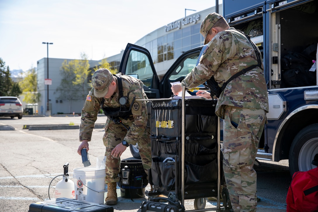 Sgt. Andrew Hunt, 103rd Civil Support Team, and Tech Sgt. Eric McComb, 103rd CST, prepare gear to respond to a simulated incident at a parking garage on the University of Alaska Anchorage campus May 18 in support of Exercise ORCA 2021. ORCA is a chemical, biological, radioactive, nuclear threats response exercise designed for participants to provide support in the aftermath of hazardous materials incidents. ORCA tests interoperability between agencies, increases opportunities for working relationships, and practices requests for assistance methods. Approximately 250 National Guardsmen from CST units in Alaska, California, Connecticut, Colorado, Idaho, Ohio, Oregon, Rhode Island, South Carolina, South Dakota, Washington, and Wisconsin are in Alaska to participate in Exercise ORCA 2021. Numerous support units and civilian agencies participated in the exercise as well. (U.S. Army National Guard photo by Spc. Grace Nechanicky)