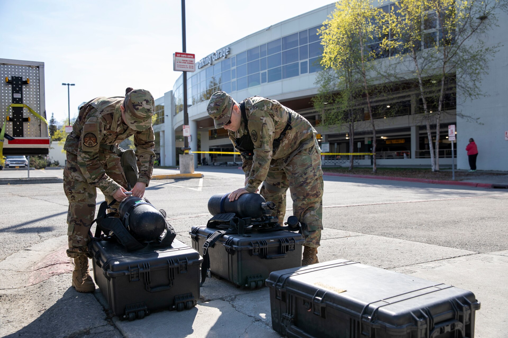 Sgt. Jason Williams, 103rd Civil Support Team, and Senior Airman Scottie Branson, 176th Civil Engineering Squadron, prepare gear to respond to a simulated incident at a parking garage on the University of Alaska Anchorage campus May 18, in support of Exercise ORCA 2021. ORCA is a chemical, biological, radioactive, nuclear threats response exercise designed for participants to provide support in the aftermath of hazardous materials incidents. ORCA tests interoperability between agencies, increases opportunities for working relationships, and practices requests for assistance methods. Approximately 250 National Guardsmen from CST units in Alaska, California, Connecticut, Colorado, Idaho, Ohio, Oregon, Rhode Island, South Carolina, South Dakota, Washington, and Wisconsin are in Alaska to participate in Exercise ORCA 2021. Numerous support units and civilian agencies participated in the exercise as well. (U.S. Army National Guard photo by Spc. Grace Nechanicky)