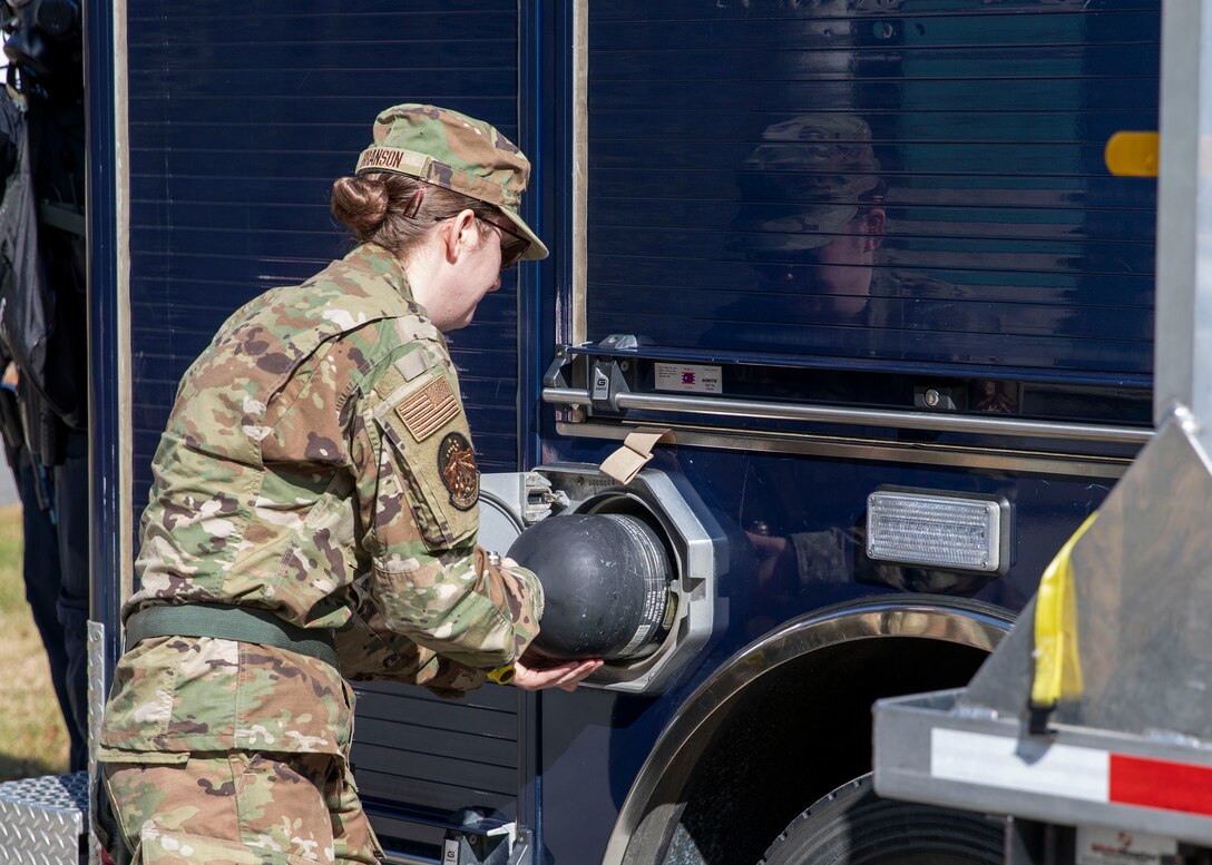 Senior Airman Scottie Branson, 176th Civil Engineering Squadron, prepares gear for members of the 103rd Civil Support Team to respond to a simulated incident at a parking garage on the University of Alaska Anchorage campus May 18, in support of Exercise ORCA 2021. ORCA is a chemical, biological, radioactive, nuclear threats response exercise designed for participants to provide support in the aftermath of hazardous materials incidents. ORCA tests interoperability between agencies, increases opportunities for working relationships, and practices requests for assistance methods. Approximately 250 National Guardsmen from CST units in Alaska, California, Connecticut, Colorado, Idaho, Ohio, Oregon, Rhode Island, South Carolina, South Dakota, Washington, and Wisconsin are in Alaska to participate in Exercise ORCA 2021. Numerous support units and civilian agencies participated in the exercise as well. (U.S. Army National Guard photo by Spc. Grace Nechanicky)