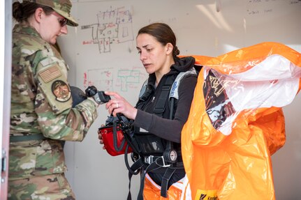 Sgt. Fabiana Kirtley, 103rd Civil Support Team, suits up as a back-up team member for a simulated incident at the Anchorage Fire Training Center, May 19, in support of Exercise ORCA 2021. ORCA is a chemical, biological, radioactive, nuclear threats response exercise designed for participants to provide support in the aftermath of hazardous materials incidents. ORCA tests interoperability between agencies, increases opportunities for working relationships, and practices requests for assistance methods. Approximately 250 National Guardsmen from CST units in Alaska, California, Connecticut, Colorado, Idaho, Ohio, Oregon, Rhode Island, South Carolina, South Dakota, Washington, and Wisconsin are in Alaska to participate in Exercise ORCA 2021. Numerous support units and civilian agencies participated in the exercise as well. (U.S. Army National Guard photo by Spc. Grace Nechanicky)
