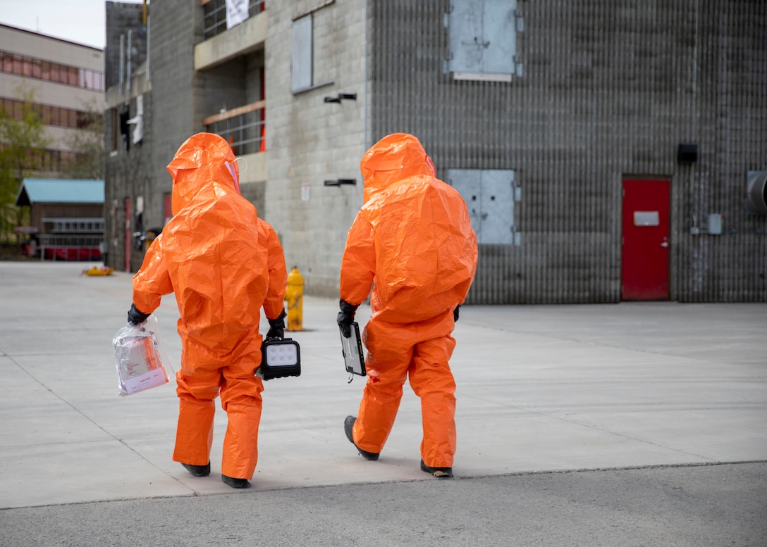 Sgt. Anthony Luiken, 103rd Civil Support Team, and Staff Sgt. Jonathan Ramos, 103rd CST, prepare to enter a tower and respond to a simulated incident at the Anchorage Fire Training Center, May 19, in support of Exercise ORCA 2021. ORCA is a chemical, biological, radioactive, nuclear threats response exercise designed for participants to provide support in the aftermath of hazardous materials incidents. ORCA tests interoperability between agencies, increases opportunities for working relationships, and practices requests for assistance methods. Approximately 250 National Guardsmen from CST units in Alaska, California, Connecticut, Colorado, Idaho, Ohio, Oregon, Rhode Island, South Carolina, South Dakota, Washington, and Wisconsin are in Alaska to participate in Exercise ORCA 2021. Numerous support units and civilian agencies participated in the exercise as well. (U.S. Army National Guard photo by Spc. Grace Nechanicky)