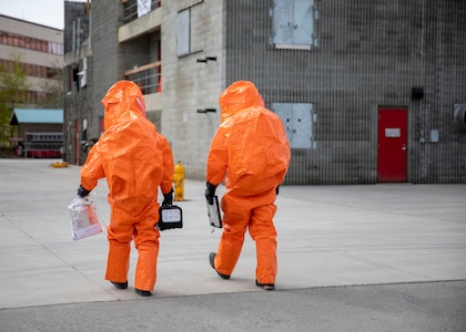 Sgt. Anthony Luiken, 103rd Civil Support Team, and Staff Sgt. Jonathan Ramos, 103rd CST, prepare to enter a tower and respond to a simulated incident at the Anchorage Fire Training Center, May 19, in support of Exercise ORCA 2021. ORCA is a chemical, biological, radioactive, nuclear threats response exercise designed for participants to provide support in the aftermath of hazardous materials incidents. ORCA tests interoperability between agencies, increases opportunities for working relationships, and practices requests for assistance methods. Approximately 250 National Guardsmen from CST units in Alaska, California, Connecticut, Colorado, Idaho, Ohio, Oregon, Rhode Island, South Carolina, South Dakota, Washington, and Wisconsin are in Alaska to participate in Exercise ORCA 2021. Numerous support units and civilian agencies participated in the exercise as well. (U.S. Army National Guard photo by Spc. Grace Nechanicky)