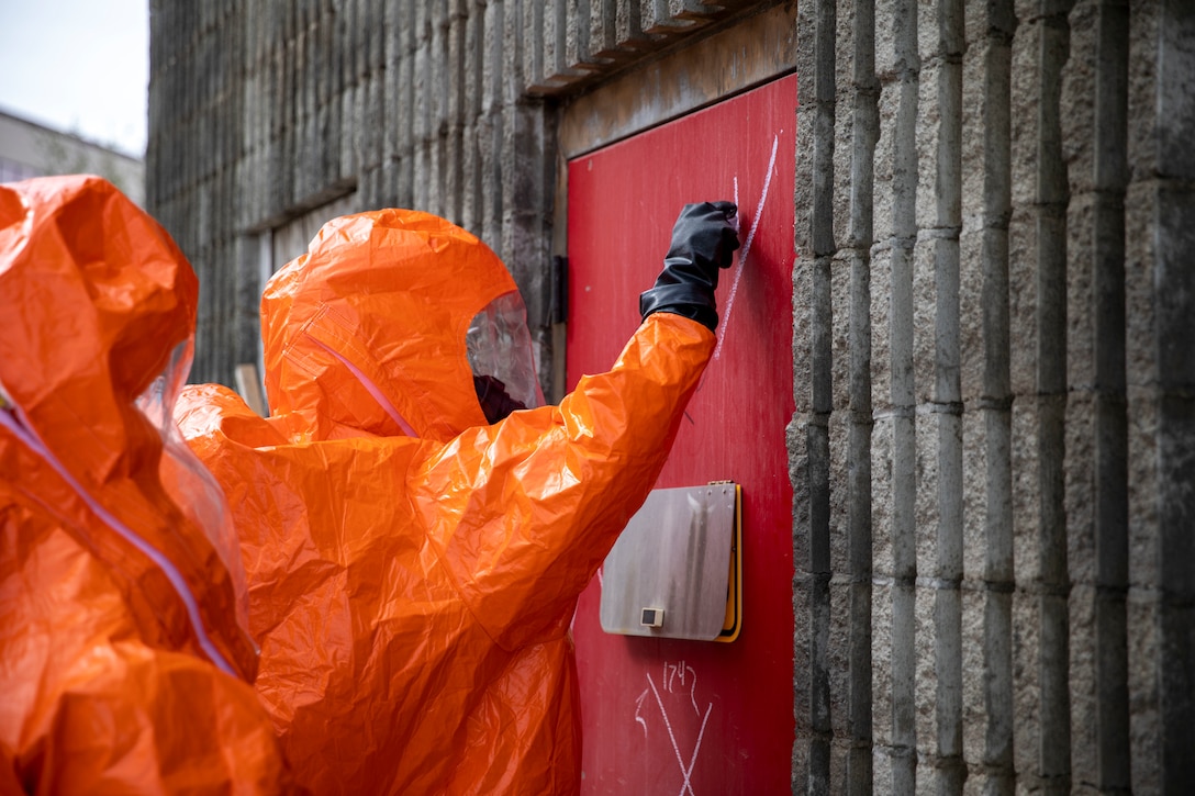 Sgt. Anthony Luiken, 103rd Civil Support Team, and Staff Sgt. Jonathan Ramos, 103rd CST, prepare to enter a tower and respond to a simulated incident at the Anchorage Fire Training Center, May 19, in support of Exercise ORCA 2021. ORCA is a chemical, biological, radioactive, nuclear threats response exercise designed for participants to provide support in the aftermath of hazardous materials incidents. ORCA tests interoperability between agencies, increases opportunities for working relationships, and practices requests for assistance methods. Approximately 250 National Guardsmen from CST units in Alaska, California, Connecticut, Colorado, Idaho, Ohio, Oregon, Rhode Island, South Carolina, South Dakota, Washington, and Wisconsin are in Alaska to participate in Exercise ORCA 2021. Numerous support units and civilian agencies participated in the exercise as well. (U.S. Army National Guard photo by Spc. Grace Nechanicky)