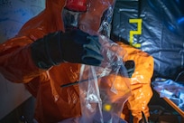 Sgt. Anthony Luiken, 103rd Civil Support Team, and Staff Sgt. Jonathan Ramos, 103rd CST, collect and seal samples at a simulated incident at the Anchorage Fire Training Center, May 19, in support of Exercise ORCA 2021. ORCA is a chemical, biological, radioactive, nuclear threats response exercise designed for participants to provide support in the aftermath of hazardous materials incidents. ORCA tests interoperability between agencies, increases opportunities for working relationships, and practices requests for assistance methods. Approximately 250 National Guardsmen from CST units in Alaska, California, Connecticut, Colorado, Idaho, Ohio, Oregon, Rhode Island, South Carolina, South Dakota, Washington, and Wisconsin are in Alaska to participate in Exercise ORCA 2021. Numerous support units and civilian agencies participated in the exercise as well. (U.S. Army National Guard photo by Spc. Grace Nechanicky)