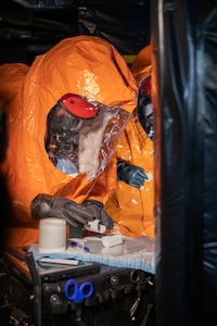 Sgt. Anthony Luiken, 103rd Civil Support Team, and Staff Sgt. Jonathan Ramos, 103rd CST, collect and seal samples at a simulated incident at the Anchorage Fire Training Center, May 19, in support of Exercise ORCA 2021. ORCA is a chemical, biological, radioactive, nuclear threats response exercise designed for participants to provide support in the aftermath of hazardous materials incidents. ORCA tests interoperability between agencies, increases opportunities for working relationships, and practices requests for assistance methods. Approximately 250 National Guardsmen from CST units in Alaska, California, Connecticut, Colorado, Idaho, Ohio, Oregon, Rhode Island, South Carolina, South Dakota, Washington, and Wisconsin are in Alaska to participate in Exercise ORCA 2021. Numerous support units and civilian agencies participated in the exercise as well. (U.S. Army National Guard photo by Spc. Grace Nechanicky)