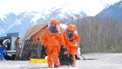 Team members of the 82nd Civil Support Team from the South Dakota National Guard prepare to enter a building to respond to a simulated incident at the Alaska Railroad train yard in Seward, Alaska, May 18, 2021 in support of Exercise ORCA 21. ORCA is a chemical, biological, radioactive, nuclear threats response exercise designed for participants to provide support in the aftermath of hazardous materials incidents. ORCA tests interoperability between agencies, increases opportunities for working relationships, and practices requests for assistance methods. Approximately 250 National Guardsmen from CST units in Alaska, California, Connecticut, Colorado, Idaho, Ohio, Oregon, Rhode Island, South Carolina, South Dakota, Washington, and Wisconsin are in Alaska to participate in Exercise ORCA 2021. Numerous support units and civilian agencies participated in the exercise as well. (U.S. Army National Guard photo by Dana Rosso)