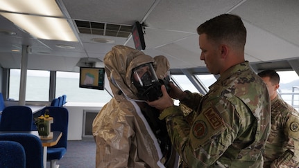 Tech. Sgt. Dennis Haubrich Medical noncommissioned officer assigned to the 13th Civil Support team, Rhode Island National Guard, inspects the filter element attached to the initial response team member’s facemask prior to his entry into the simulated incident site aboard the Glacier Express vessel cruising through Resurrection Bay off of the coast of Seward, Alaska, May 19, in support of Exercise ORCA 21. ORCA is a chemical, biological, radioactive, nuclear threats response exercise designed for participants to provide support in the aftermath of hazardous materials incidents. ORCA tests interoperability between agencies, increases opportunities for working relationships, and practices requests for assistance methods. Approximately 250 National Guardsmen from CST units in Alaska, California, Connecticut, Colorado, Idaho, Ohio, Oregon, Rhode Island, South Carolina, South Dakota, Washington, and Wisconsin are in Alaska to participate in Exercise ORCA 2021. Numerous support units and civilian agencies participated in the exercise as well. (U.S. Army National Guard photo by Dana Rosso)