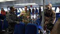 1st Sgt. Steve Freeland, 102nd Civil Support Team, Oregon National Guard, conducts a post event briefing with members of the 82nd Civil Support Team, South Dakota National Guard, and the 102nd Civil Support Team, Oregon National Guard, at the conclusion of entry into the simulated incident site aboard the Glacier Express vessel cruising through Resurrection Bay off of the coast of Seward, Alaska, May 19, in support of Exercise ORCA 21. ORCA is a chemical, biological, radioactive, nuclear threats response exercise designed for participants to provide support in the aftermath of hazardous materials incidents. ORCA tests interoperability between agencies, increases opportunities for working relationships, and practices requests for assistance methods. Approximately 250 National Guardsmen from CST units in Alaska, California, Connecticut, Colorado, Idaho, Ohio, Oregon, Rhode Island, South Carolina, South Dakota, Washington, and Wisconsin are in Alaska to participate in Exercise ORCA 2021. Numerous support units and civilian agencies participated in the exercise as well. (U.S. Army National Guard photo by Dana Rosso)