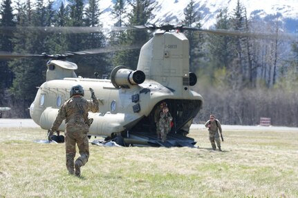 An aircrew member with 1st Battalion, 207th Aviation Regiment, Alaska Army National Guard, directs members of the 82nd Civil Support Team, from the South Dakota National Guard, away from the aircraft after arriving in the city of Seward, Alaska, May 18, in support of Exercise ORCA 21. The 82nd CST was the initial response team responsible for conducting a scene assessment, establishing the staging areas as well as the on-scene command post, and conducting the initial entry into the incident location. ORCA is a chemical, biological, radioactive, nuclear threats response exercise designed for participants to provide support in the aftermath of hazardous materials incidents. ORCA tests interoperability between agencies, increases opportunities for working relationships, and practices requests for assistance methods. Approximately 250 National Guardsmen from CST units in Alaska, California, Connecticut, Colorado, Idaho, Ohio, Oregon, Rhode Island, South Carolina, South Dakota, Washington, and Wisconsin are in Alaska to participate in Exercise ORCA 2021. Numerous support units and civilian agencies participated in the exercise as well. (U.S. Army National Guard photo by Dana Rosso)