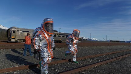 Team members of the 102nd Civil Support Team from the Oregon National Guard transition to the decontamination area after responding to a simulated incident at the Alaska Railroad train yard in Seward, Alaska, May 18, in support of Exercise ORCA 21. ORCA is a chemical, biological, radioactive, nuclear threats response exercise designed for participants to provide support in the aftermath of hazardous materials incidents. ORCA tests interoperability between agencies, increases opportunities for working relationships, and practices requests for assistance methods. Approximately 250 National Guardsmen from CST units in Alaska, California, Connecticut, Colorado, Idaho, Ohio, Oregon, Rhode Island, South Carolina, South Dakota, Washington, and Wisconsin are in Alaska to participate in Exercise ORCA 2021. Numerous support units and civilian agencies participated in the exercise as well. (U.S. Army National Guard photo by Dana Rosso)