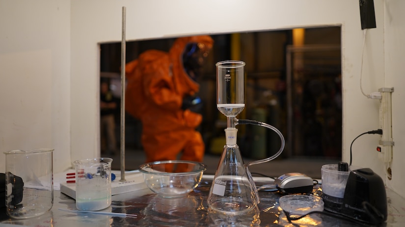 A member of the 82nd Civil Support Team from the South Dakota National Guard passes by a simulated lab while conducting initial assessment of the incident location in Seward, Alaska, May 18, in support of Exercise ORCA 21. ORCA is a chemical, biological, radioactive, nuclear threats response exercise designed for participants to provide support in the aftermath of hazardous materials incidents. ORCA tests interoperability between agencies, increases opportunities for working relationships, and practices requests for assistance methods. Approximately 250 National Guardsmen from CST units in Alaska, California, Connecticut, Colorado, Idaho, Ohio, Oregon, Rhode Island, South Carolina, South Dakota, Washington, and Wisconsin are in Alaska to participate in Exercise ORCA 2021. Numerous support units and civilian agencies participated in the exercise as well. (U.S. Army National Guard photo by Dana Rosso)