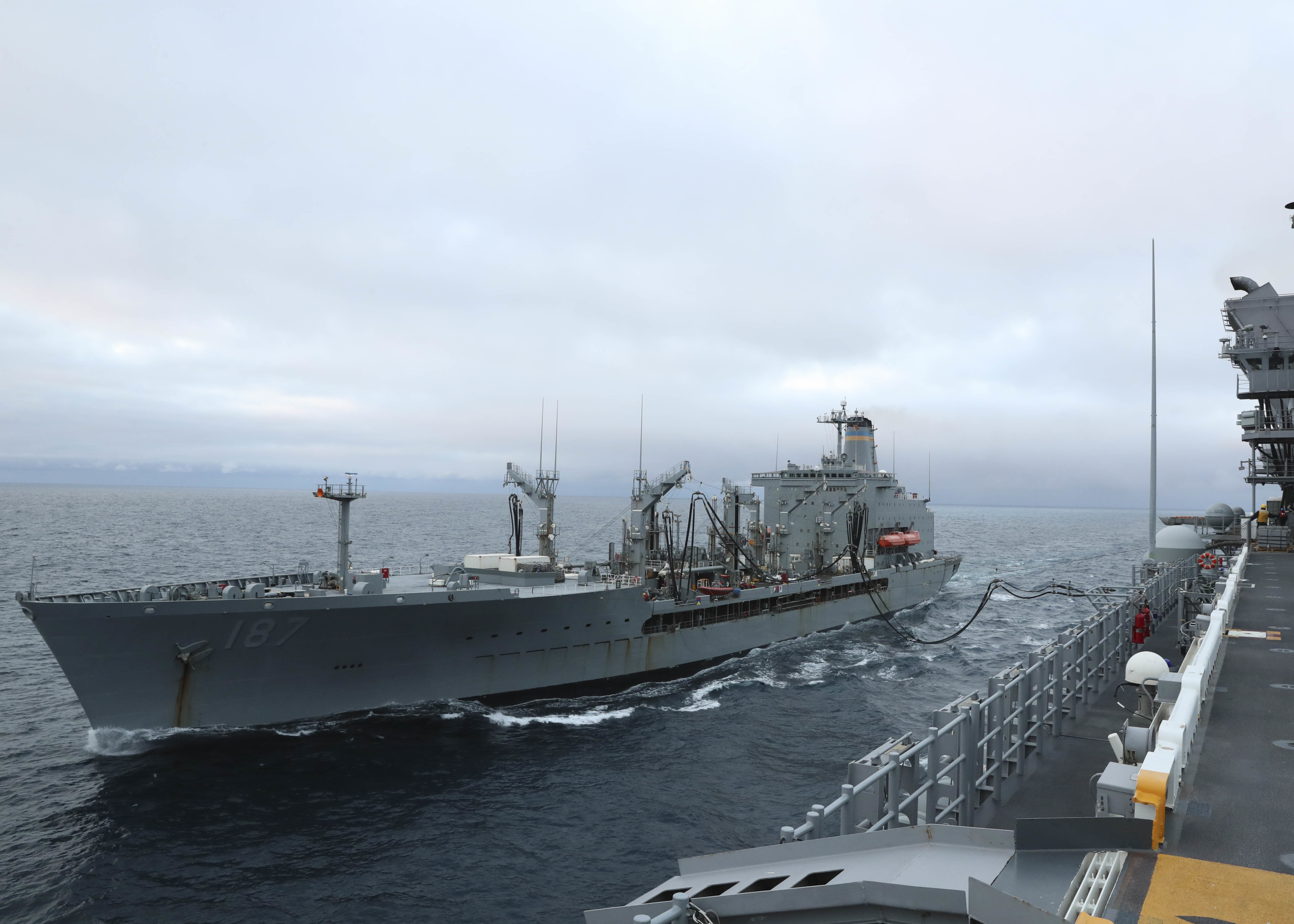 The fleet replenishment oiler USNS Henry J. Kaiser (T-AO 187) refuels amphibious assault ship USS Tripoli (LHA 7) during Tripoli�s first replenishment-at-sea (RAS), May 16, 2021.