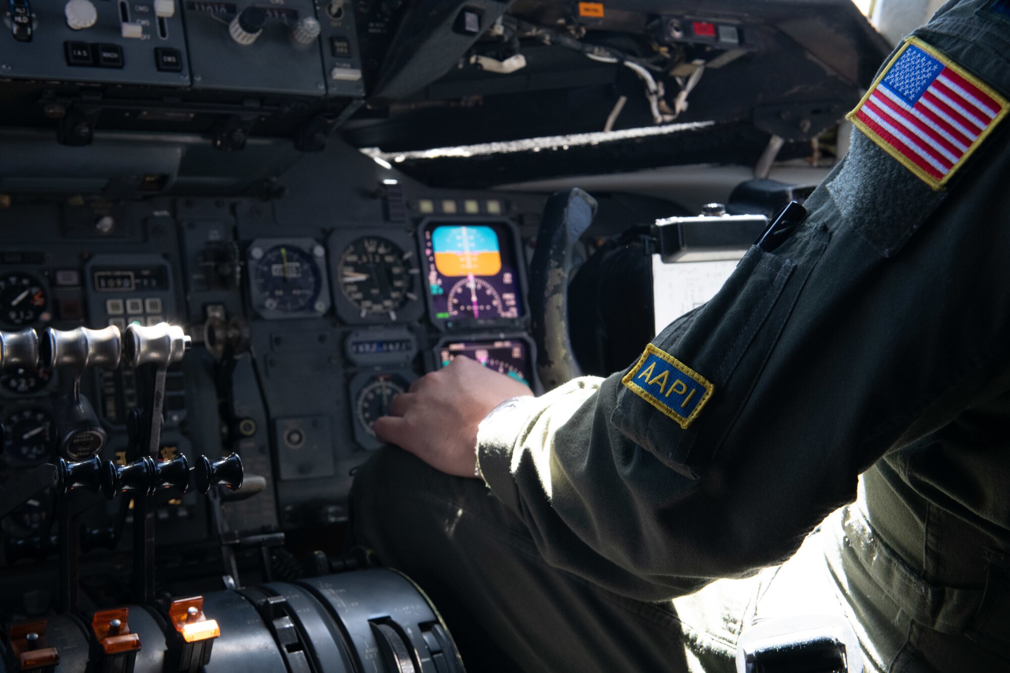 Medium shot of left arm of pilot at controls of KC-10 Extender.