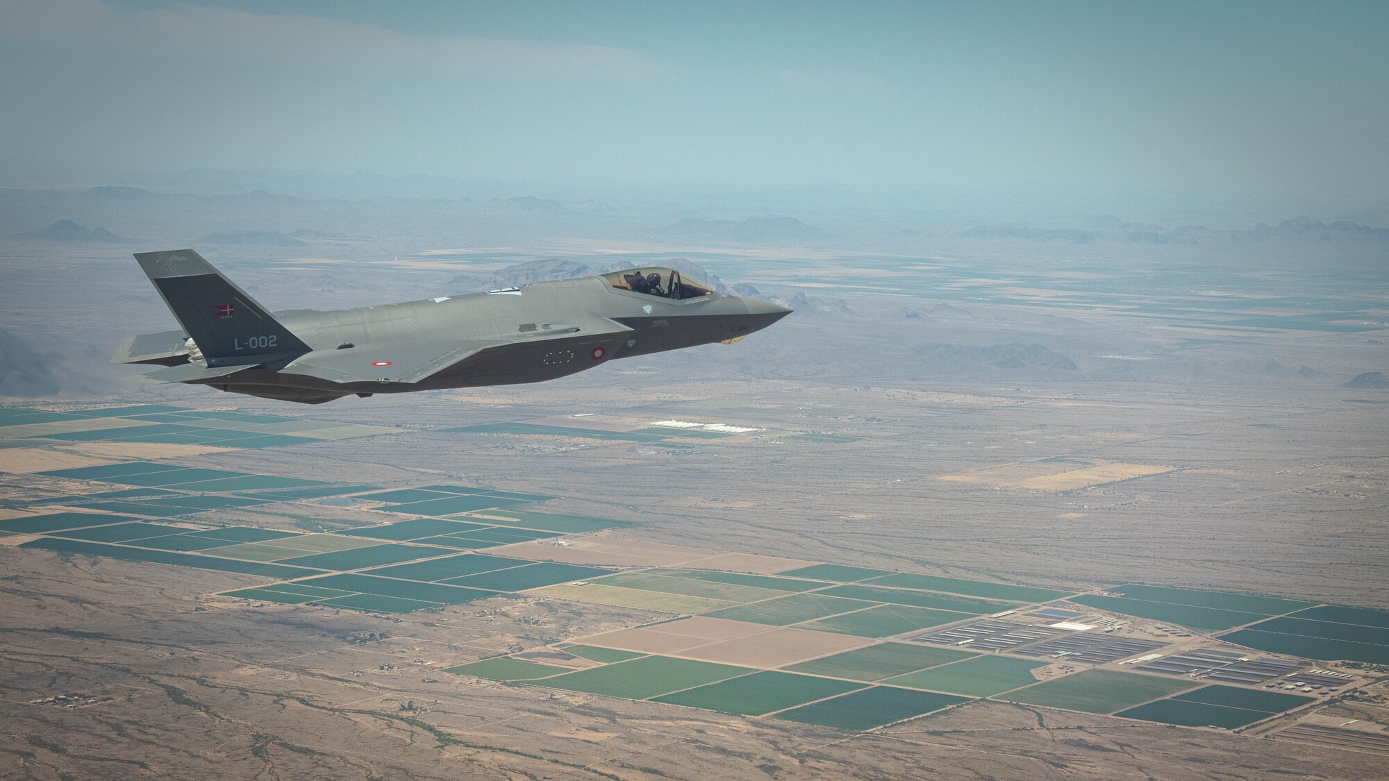 A Royal Danish Air Force F-35A Lightning II fighter jet assigned to the 308th Fighter Squadron at Luke Air Force Base soars over Bagdad, Arizona, May 5, 2021.