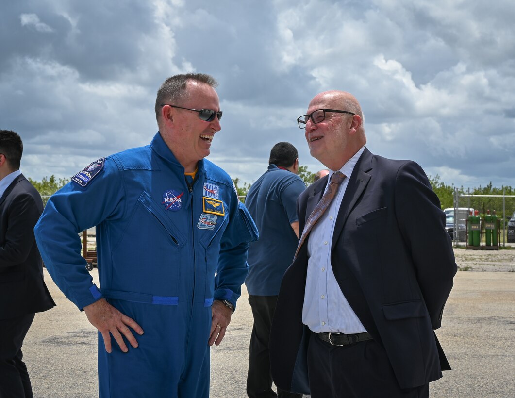 Acting Secretary of the Air Force John P. Roth, speaks with Barry Eugene "Butch" Wilmore, NASA astronaut, at Cape Canaveral Space Force Station, Fla., May 17, 2021. During his visit, Roth toured several facilities at CCSFS and met with Airmen and Guardians supporting space launch operations. (U.S. Space Force photo by Airman 1st Class Thomas Sjoberg)