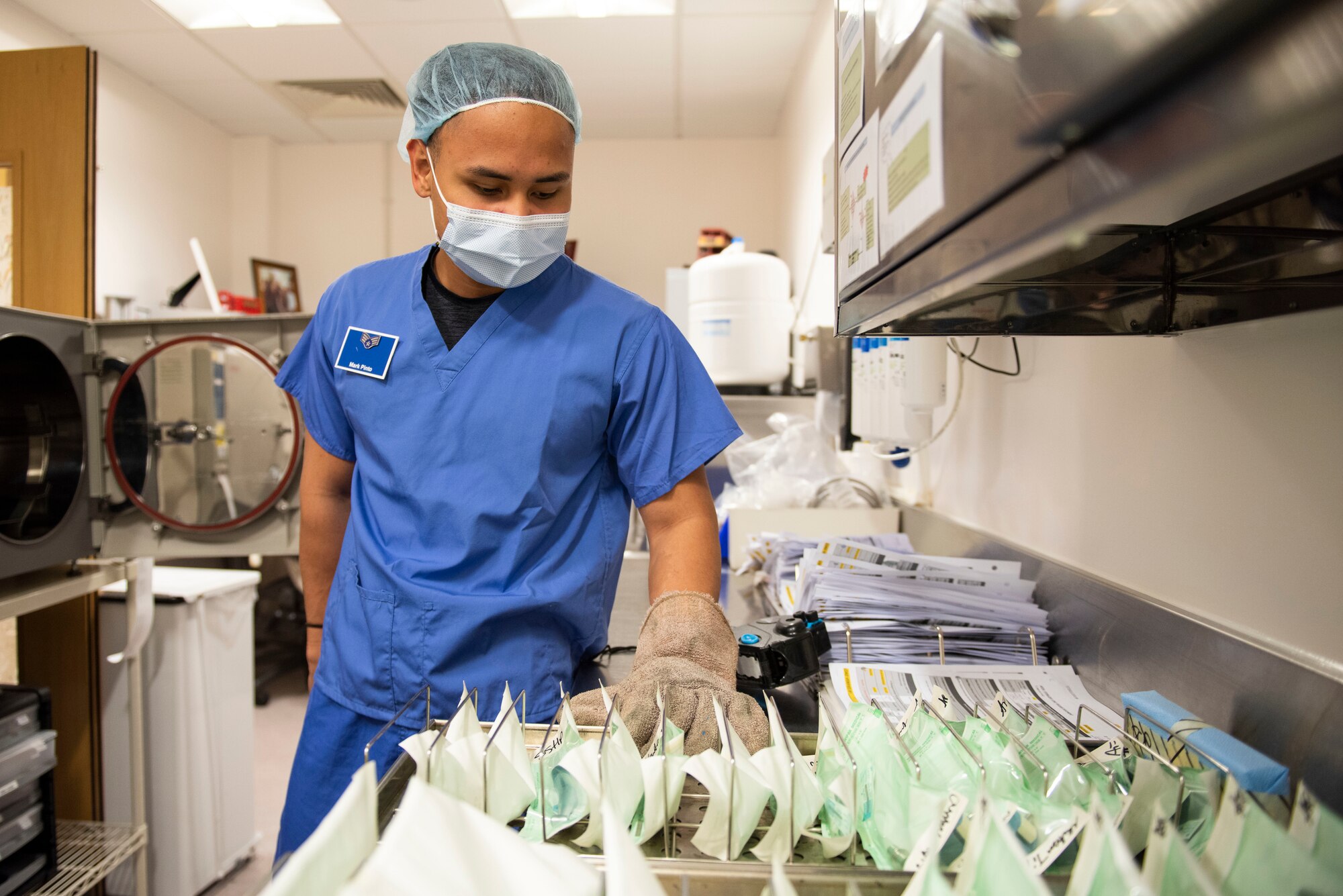 U.S. Air Force Senior Airman Mark Pinto, 423rd Medical Squadron dental technician, removes sterilized dental instruments ​at Royal Air Force Alconbury, England, May 11, 2021. (U.S. Air Force photo by Senior Airman Jennifer Zima)