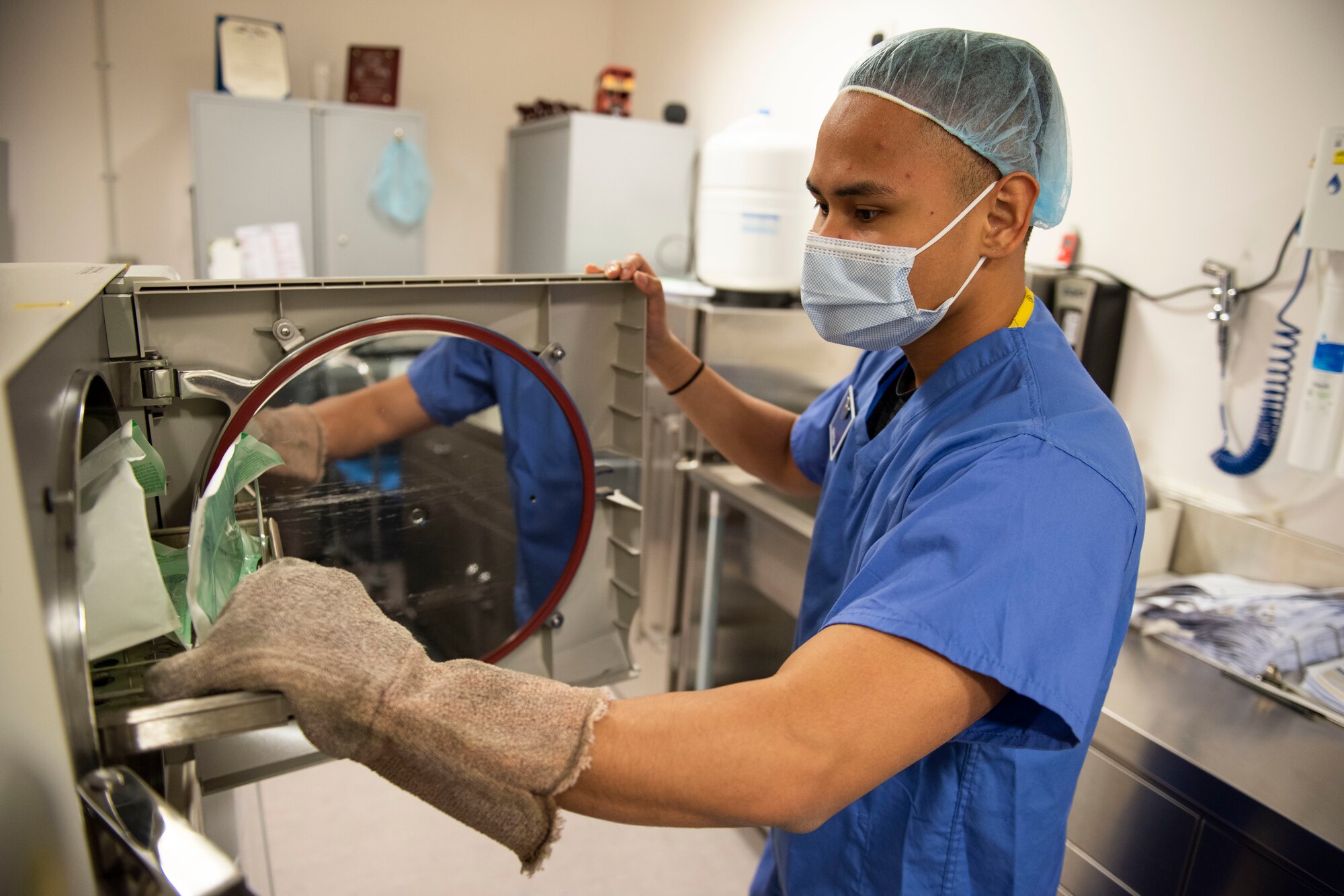 U.S. Air Force Senior Airman Mark Pinto, 423rd Medical Squadron dental technician, removes sterilized dental instruments ​at Royal Air Force Alconbury, England, May 11, 2021. (U.S. Air Force photo by Senior Airman Jennifer Zima)