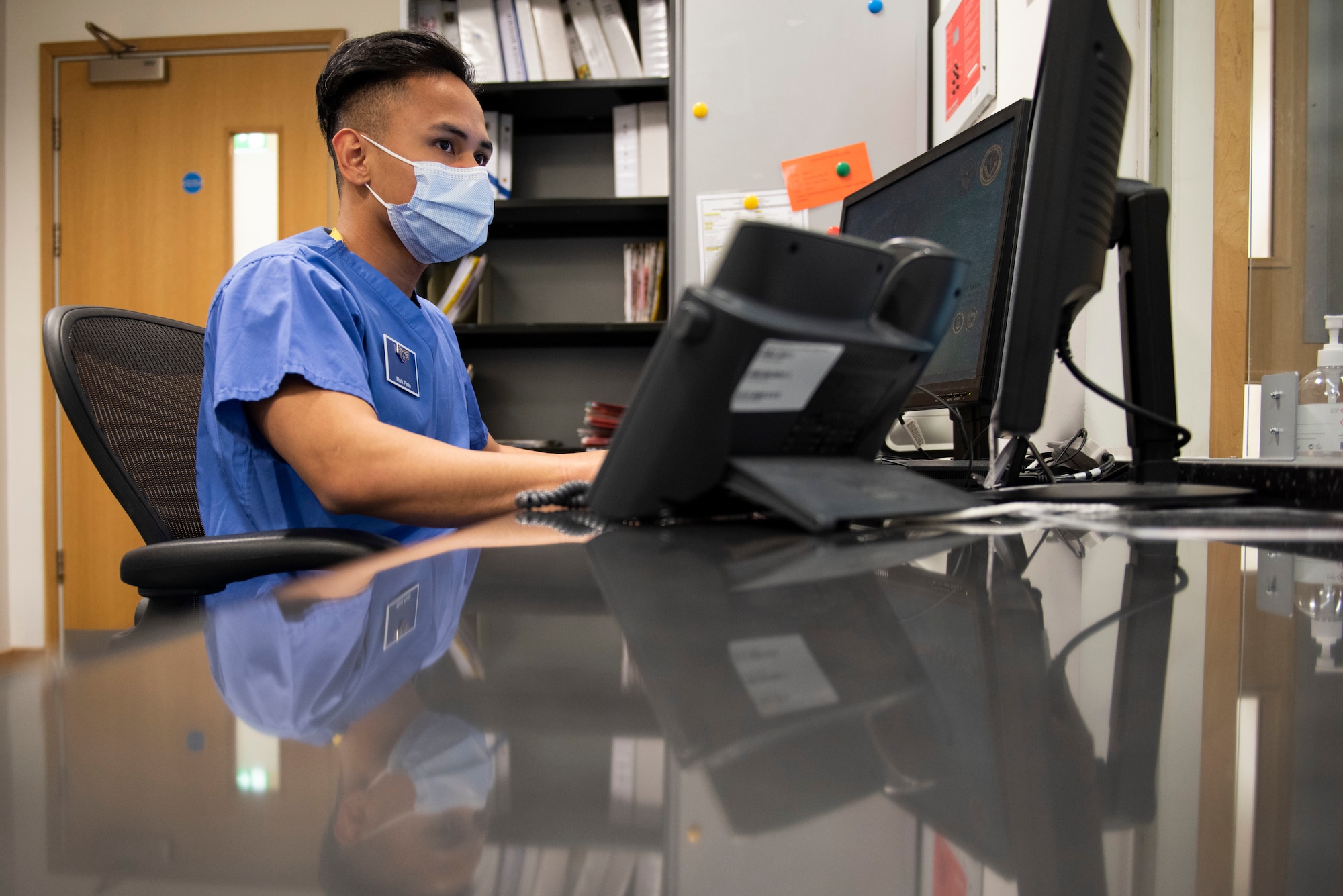 U.S. Air Force Senior Airman Mark Pinto, 423rd Medical Squadron dental technician, schedules dental patient appointments ​at Royal Air Force Alconbury, England, May 11, 2021. (U.S. Air Force photo by Senior Airman Jennifer Zima)