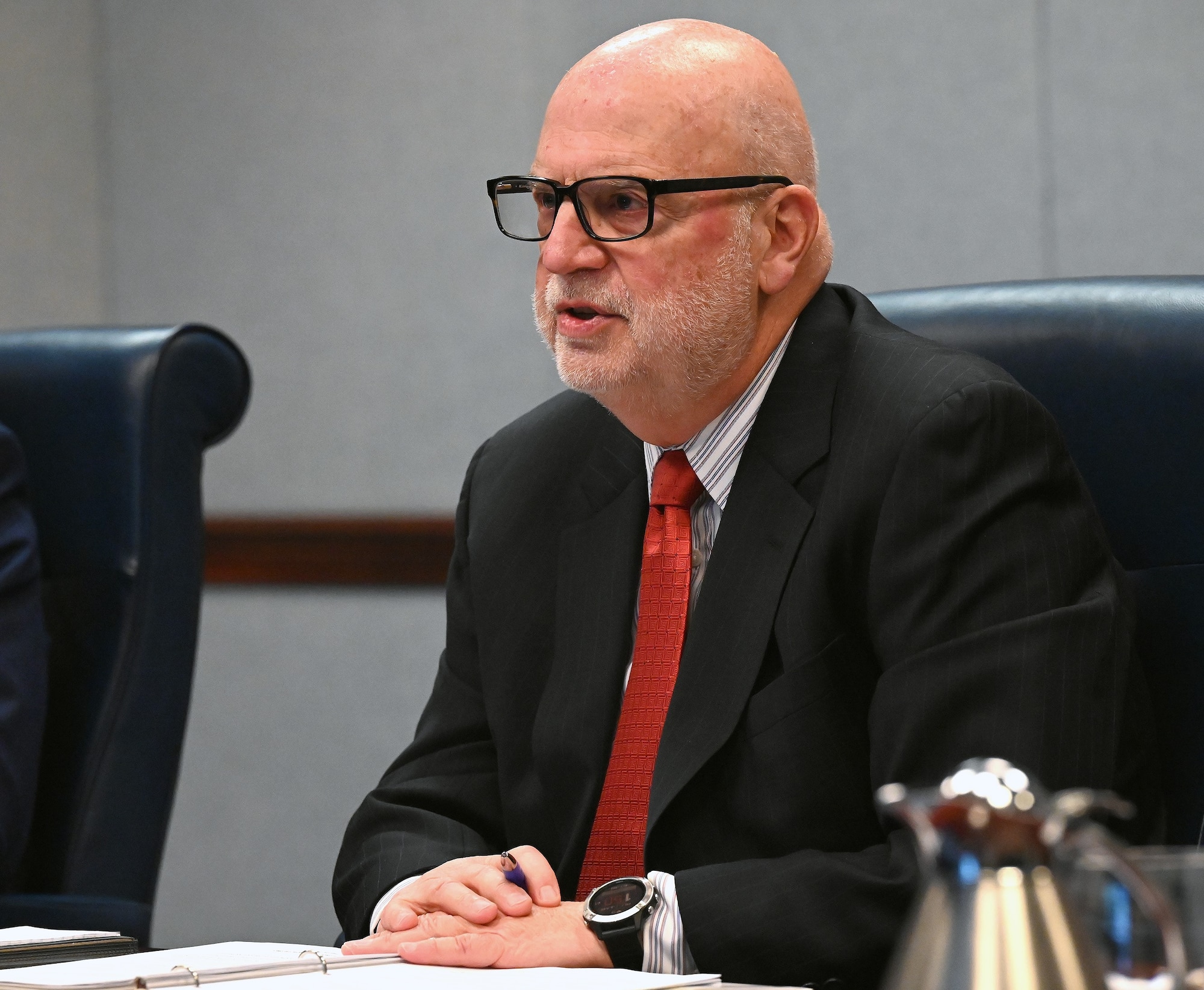 Man in meeting sitting at a table.