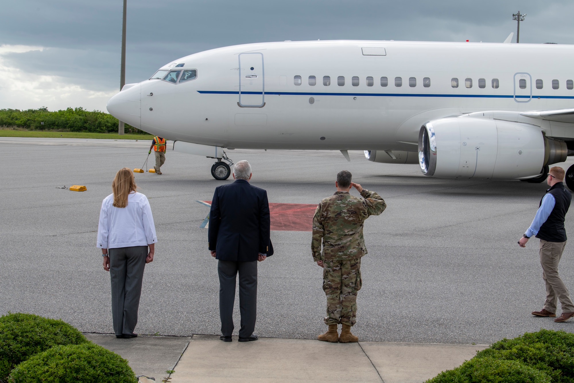 Nancy Trainer, left, Space Launch Delta 45 chief of protocol, Scott Cook, SLD 45 legislative liaison, and Col. Ed Marshall, SLD 45 vice commander of support, stand in formation as a plane with Assistant Secretary of the Air Force John P. Roth, and U.S. Space Force Gen. John W. "Jay" Raymond, Chief of Space Operations, aboard, arrives at Cape Canaveral Space Force Station, Fla., May 17, 2021. Roth and Raymond visited the installation to meet with Airmen and Guardians supporting space launch operations and learn more about the partnerships between CCSFS and commercial companies. (U.S. Air Force photo by Tech. Sgt. James Hodgman)