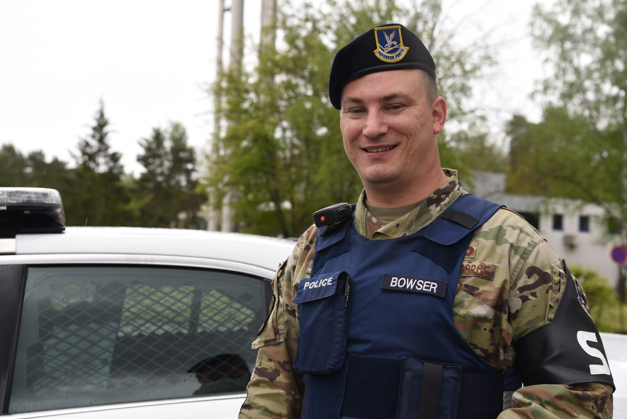 U.S. Air Force Tech. Sgt. Edwin Bowser, 569th U.S. Forces Police Squadron flight sergeant, poses near a patrol car.