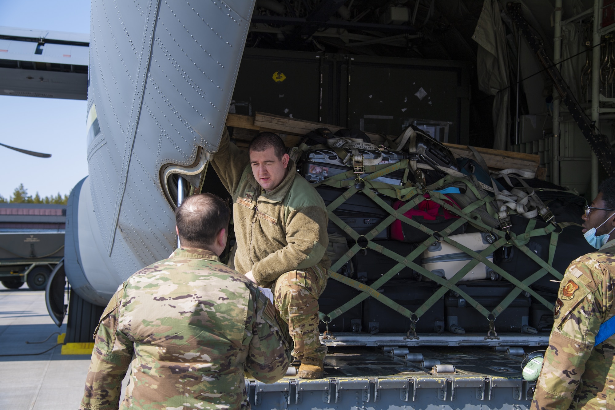 U.S. Air Force Airmen from the 52nd Fighter Wing at Spangdahlem Air Base, Germany, unload cargo from a USAF C-130 Hercules aircraft at Kallax Air Base, Sweden, May 14, 2021. The aircraft carried Airmen, personal luggage and military cargo in preparation for support of the Arctic Challenge Exercise 2021. (U.S. Air Force photo by Senior Airman Ali Stewart)