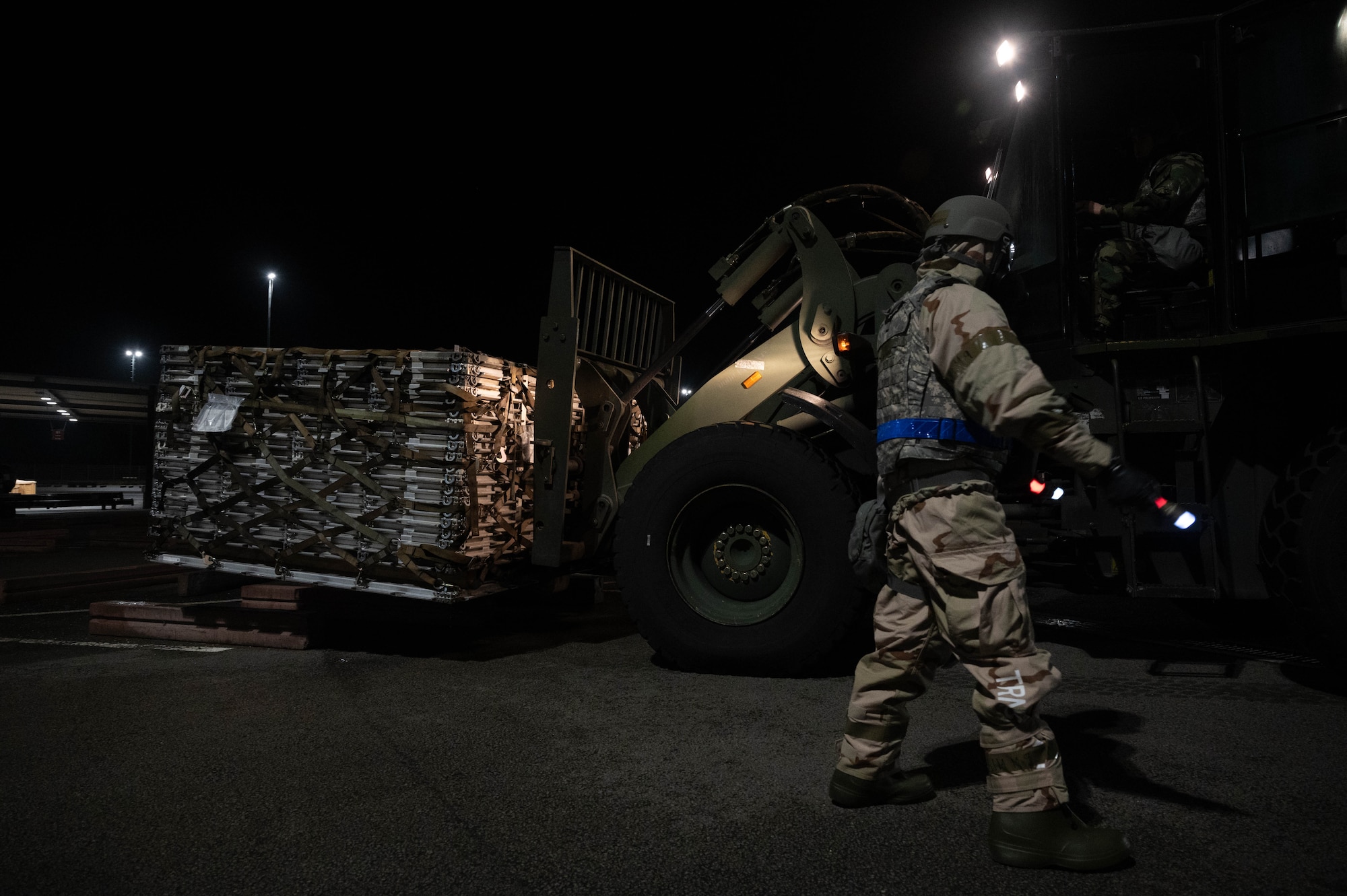 An Airman directs a forklift.