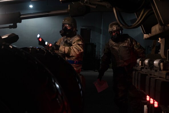 Airmen direct a forklift.