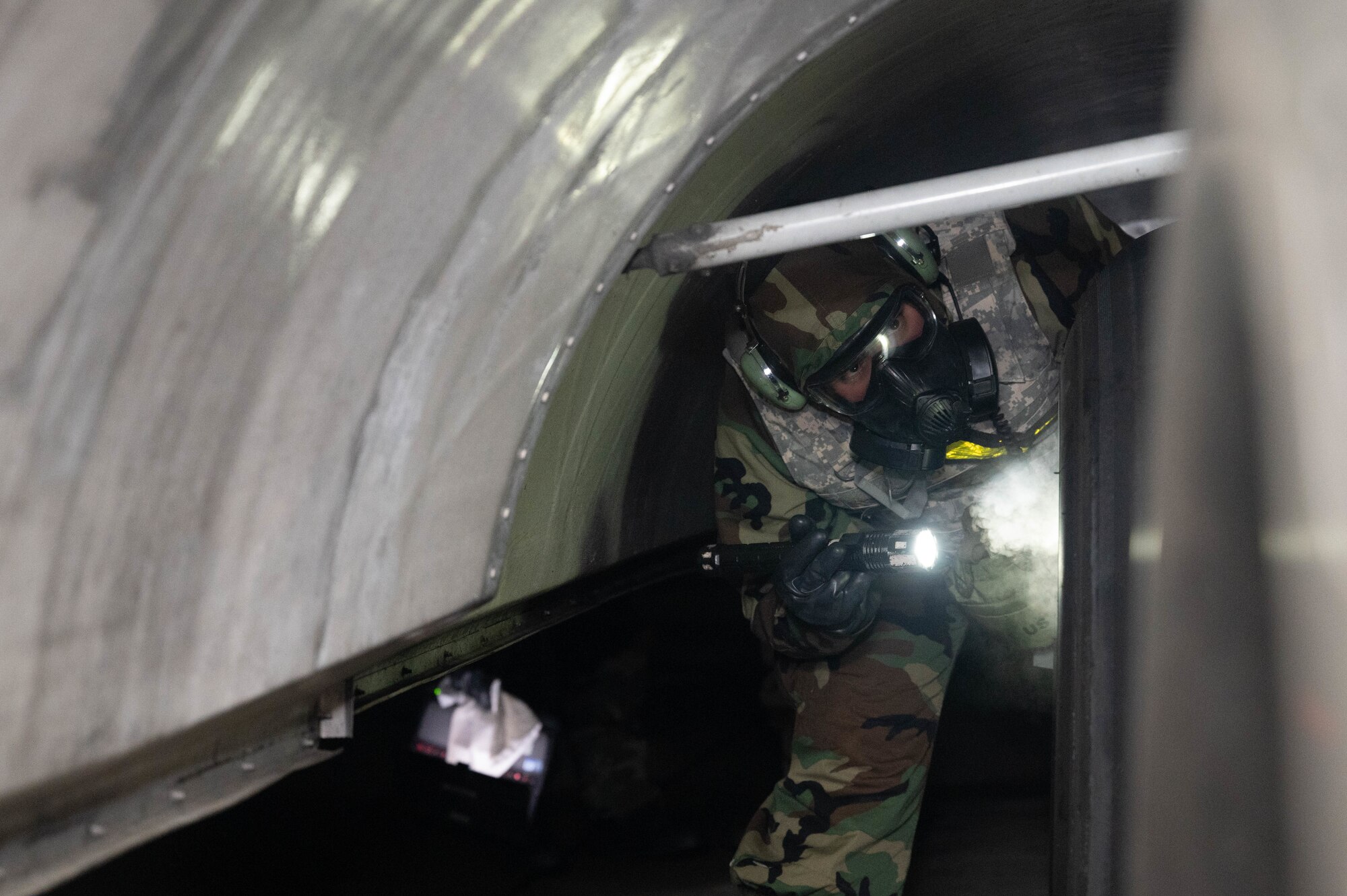 An Airman examines wheels for contamination.