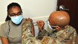 Pennsylvania Air National Guard Staff Sgt. Timi Jones, public affairs specialist for the 111th Attack Wing here, has the second dose of the COVID-19 vaccine administered by Staff Sgt. Terrell Johnson, aerospace medical technician of the 111th Medical Group, at Biddle Air National Guard Base in Horsham, Pennsylvania, May 1, 2021. The 111th Med Group has administered 913 first and second doses to the military and civilian personnel on base so far. (U.S. Air National Guard photo by Tech. Sgt. Tyrone Mitchell)