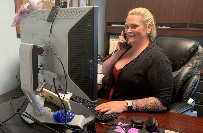 IMAGE: Jamie Hanson, a paralegal in Naval Surface Warfare Center Dahlgren Division’s Office of Counsel, answers questions for a government civilian employee over the phone. The Office is small but mighty, with ten attorneys and support staff serving the Command, technical departments and civilian employees.