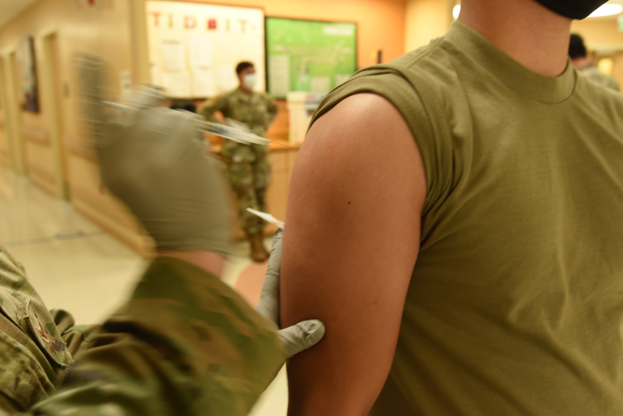 U.S. Air Force Airman 1st Class Megan Crow-Elmore, 81st Medical Group aerospace medical technician, prepares to vaccinate a fellow Airman with a syringe containing the Pfizer COVID-19 vaccine inside the Keesler Medical Center at Keesler Air Force Base, Mississippi, May 19, 2021. Crow-Elmore is part of the COVID-19 Task Force, made up of medical workers from various units in response to the pandemic. (U.S. Air Force photo by Airman 1st Class Jasmine Galloway)