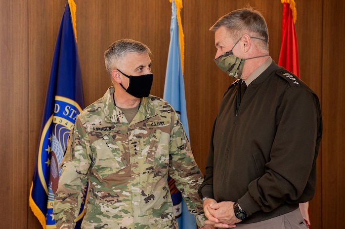 Gen. Paul M. Nakasone, U.S. Cyber Command commander and National Security Agency director, and Gen. James C. McConville, Chief of Staff of the U.S. Army, talk during their arrival to the USCYBERCOM and Army Warfighter Talks in Washington D.C., May 12, 2021.