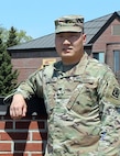 Spc. Mike Liu stands for a photo in front of the 124th Regional Training Institute at Camp Johnson, Vermont, May 20, 2021. Liu, a native of Anshan, China, joined the Vermont Army National Guard through the Military Accessions Vital to the National Interest program, which allows non-U.S. citizens with certain skills to enlist and apply for citizenship. He currently attends Army Officer Candidate School and plans to become an ordnance officer when he graduates in 2022. (U.S. Army National Guard photo by Duffy Jamieson)