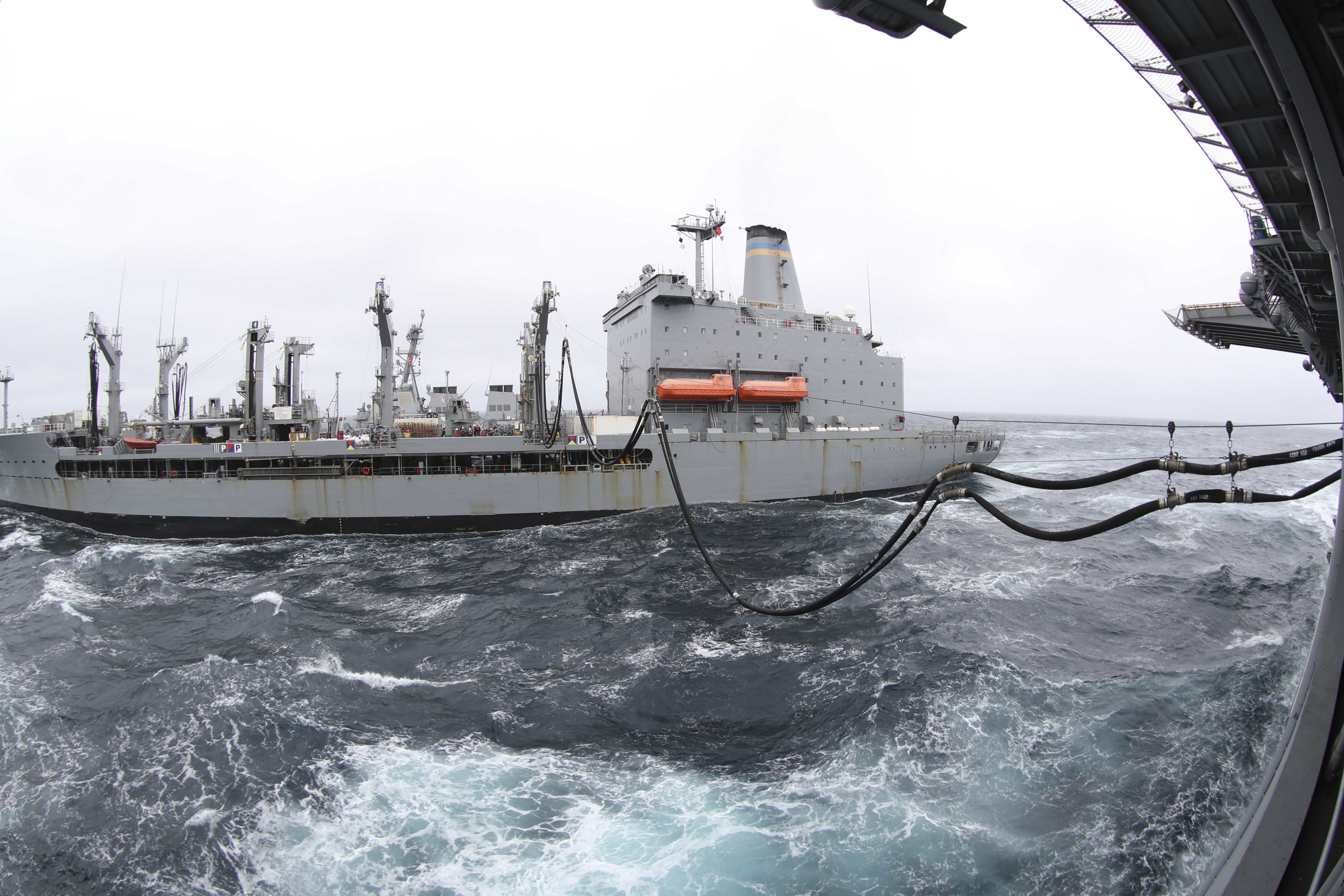The fleet replenishment oilier USNS Henry J. Kaiser (T-AO 187) conducts a replenishment-at-sea with the amphibious assault ship USS Tripoli (LHA 7).
