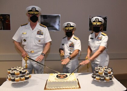 Adm. Christopher Grady, commander, U.S. Fleet Forces Command, Vice Adm. Brian Brown, and Vice Adm. Kelly Aeschbach, commander, Naval Information Forces participate in a cake-cutting ceremony during a change of command ceremony May 7. (U.S. Navy photo by Robert Fluegel/RELEASED)