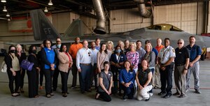 Members of the Learn, Explore, Absorb and Disseminate (LEAD) Peninsula group pose for a photo with an F-22 Raptor aircraft at Joint Base Langley-Eustis, Virginia, May 20, 2021. The LEAD program participants visited JBLE to immerse themselves in various functions and learn the role JBLE plays within the Virginia Peninsula community.