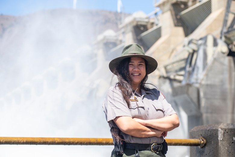 A ranger stand in front of a dam spillway.