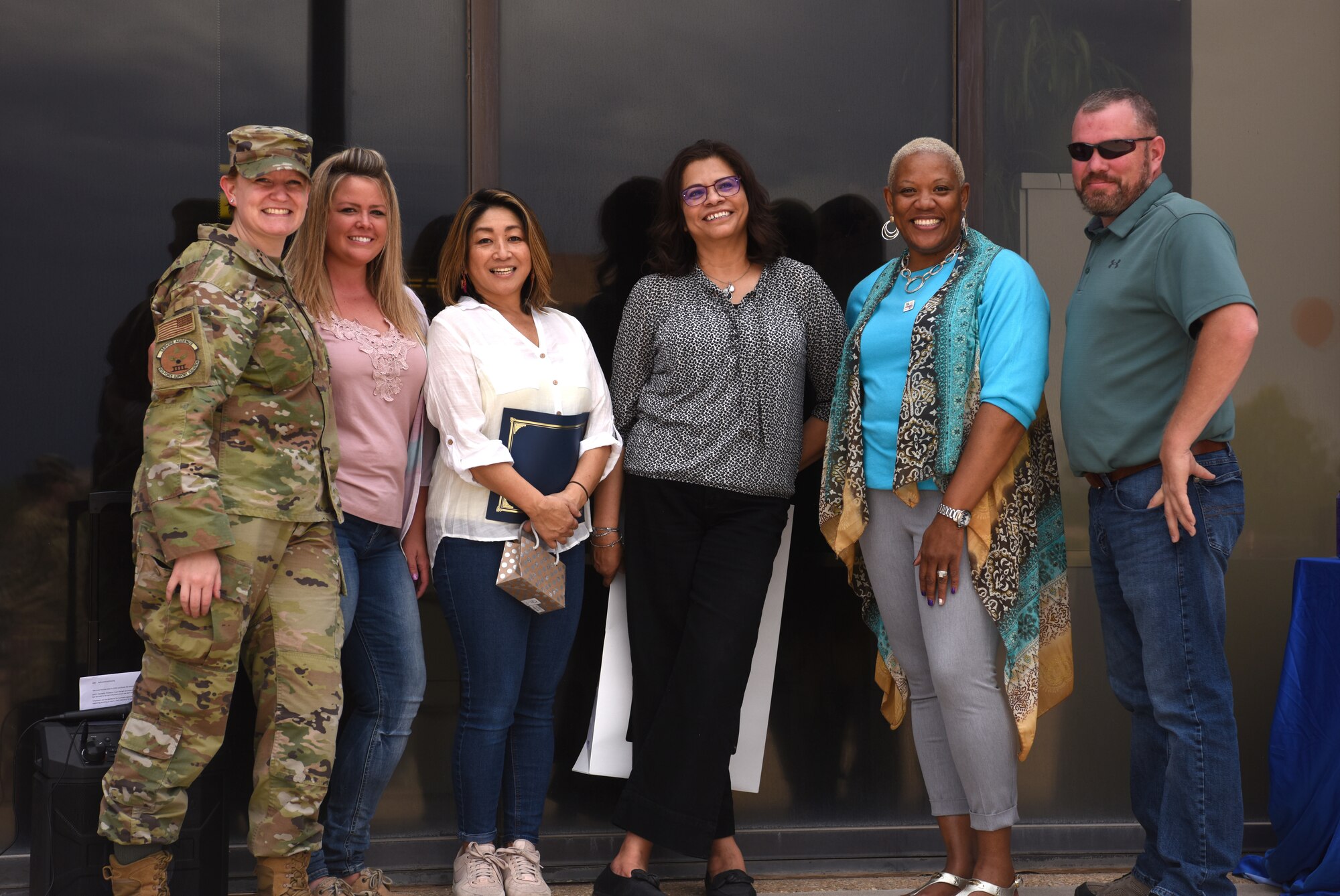 Schriever Air Force Base volunteers pose for a group photo with Community Readiness Consultant Lawanda Ervin (second from right), 50th Force Support Squadron, following an award ceremony, Schriever Air Force Base, Colorado, May 14, 2021. The 50th Force Support Squadron Airmen and Family Readiness Center hosted the award ceremony and appreciation event to thank and recognize Airmen, Guardians and their families who volunteer their time to support base and community organizations. (U.S. Space Force photo by Airman 1st Class Joshua Fontenot)