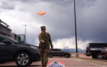 Airman 1st Class Gianina Zielke, 50th Force Support Squadron customer support apprentice, tosses a bean bag during her turn at corn hole during the Schriever Air Force Base Volunteer Appreciation Awards Ceremony, May 14, 2021. Zielke dedicates her free time volunteering at a local rescue mission that provides meals for the homeless. Volunteers from Schriever Air Force Base were recognized for their volunteer work on base and throughout the community. (U.S. Space Force photo by Airman 1st Class Joshua Fontenot)