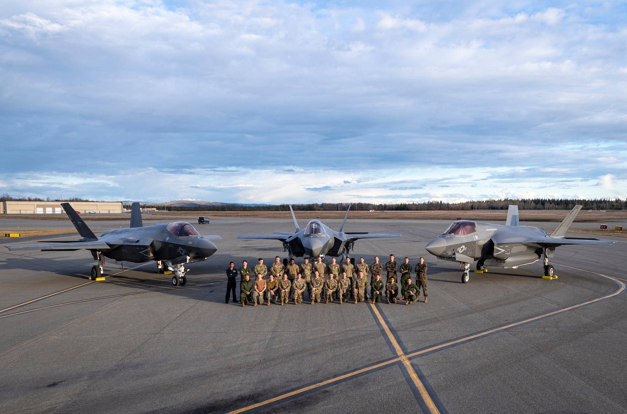 VX-9 Sailors, 354th Fighter Wing Airmen, and VMFA-122 Marine maintainers during an afternoon photo opportunity with their Joint Strike Fighters at Eielson AFB, AK during Northern Edge 21.