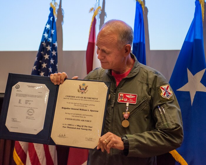 Brig. Gen. William Sparrow, Alabama National Guard Assistant Adjutant General - Air, holds his certificate of retirement May 15, 2021, at his retirement ceremony held at Dannelly Field, Ala. Sparrow retired with over 36 years of military service to his state and nation. (U.S. Air National Guard photo by Staff Sgt. Hayden Johnson)