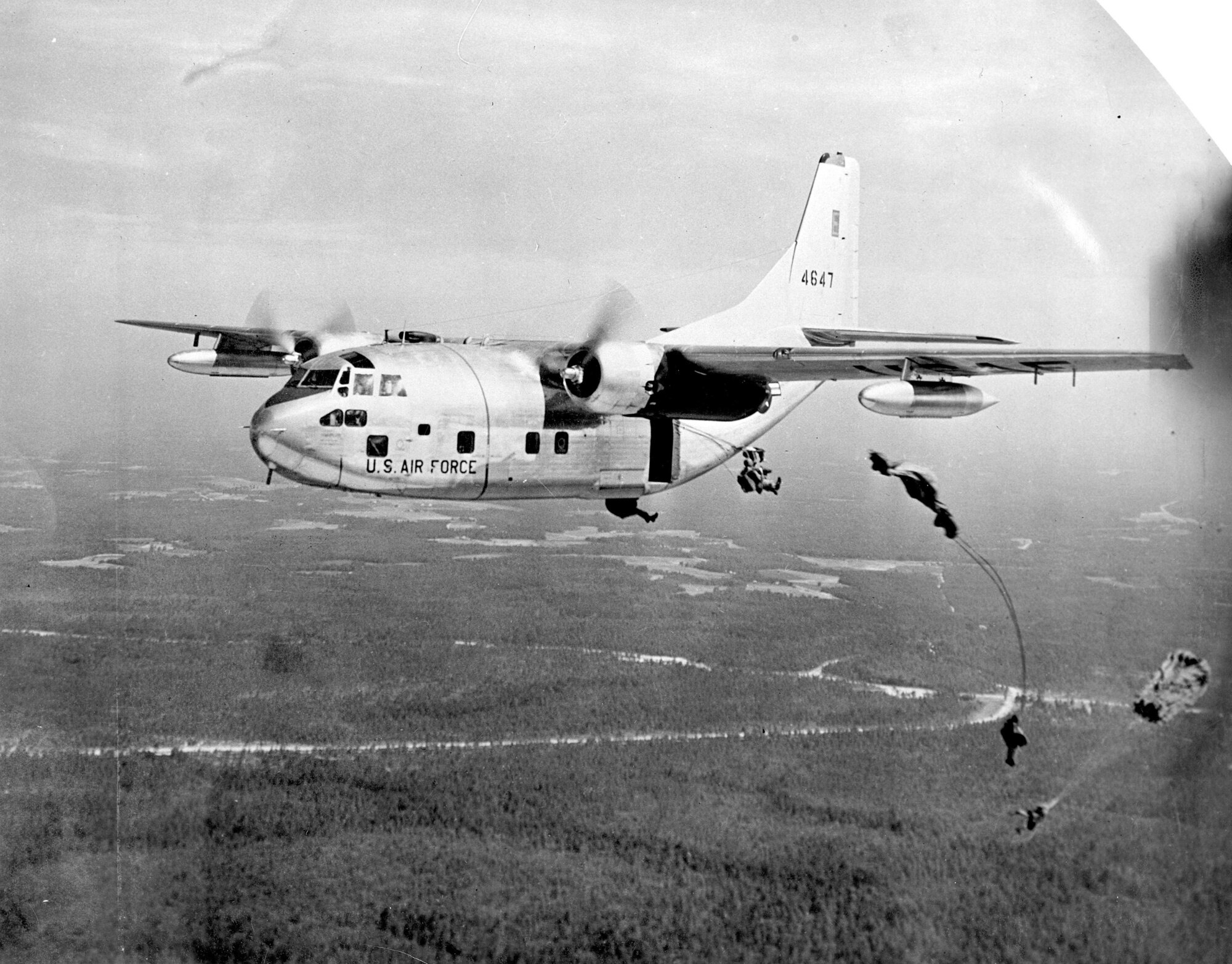 Image:  C-123 in flight over SEA with paratroopers deploying.