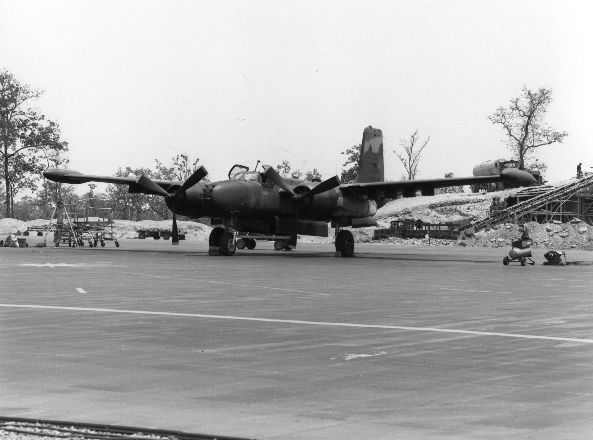 Image of A-26K parked on ramp in Southeast Asia.