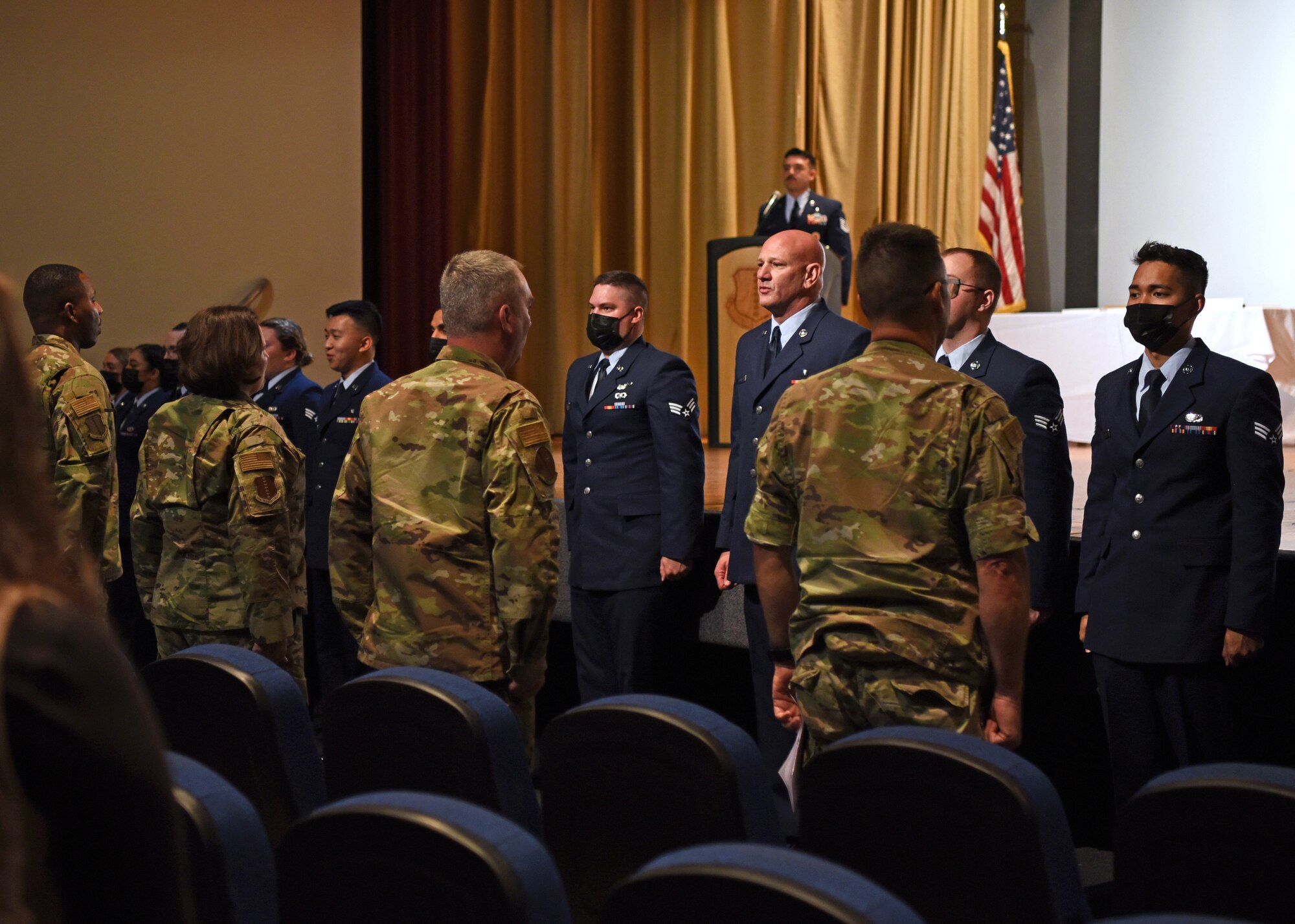Airman Leadership School graduates, Class 21-D, sing the Air Force song during their ALS graduation ceremony at the Base Theater, on Goodfellow Air Force Base, Texas, May 20, 2021. ALS focuses on developing leadership abilities, the profession of arms, and building effective communication. (U.S. Air Force photo by Senior Airman Abbey Rieves)